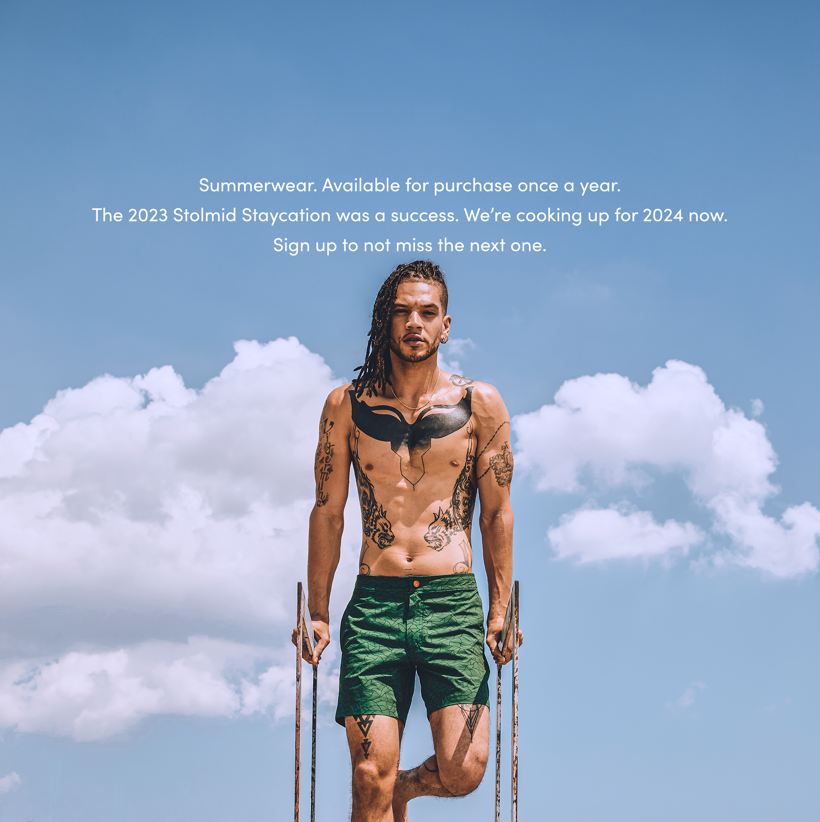 This is the first well known pair of shorts with the orange button. These are the green Phuket shorts, inspired heavily by a moment in time experience with the Mangrove Trumpet Tree leaves. The model is holding on to a fire escape for this shoot wearing the green Phuket stolmid shorts with the orange circle.